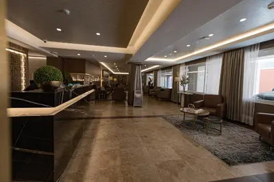 a lobby of a hotel with chairs and a bar at Hotel Presidente Huancayo - Asociado Casa Andina in Huancayo