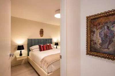 a bedroom with a bed and a painting on the wall at * Casma Residence * Private Terrace & Grill & HVAC in Lima