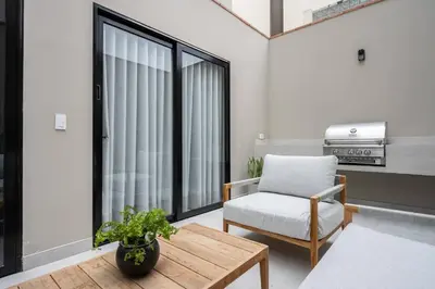 a living room with a chair and a table at * Casma Residence * Private Terrace & Grill & HVAC in Lima