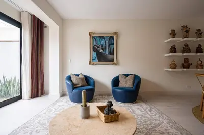 a living room with two blue chairs and a table at * Casma Residence * Private Terrace & Grill & HVAC in Lima