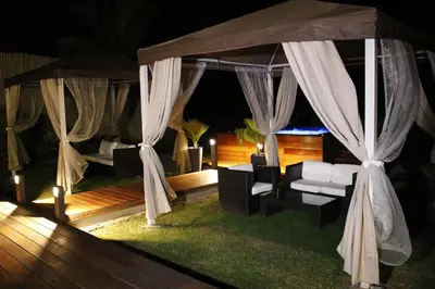 a tent with a couch in a room at night at Hotel Presidente Selva in La Merced