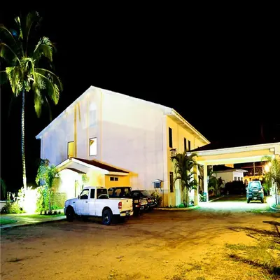 a white truck parked in front of a building at Hotel Presidente Selva in La Merced
