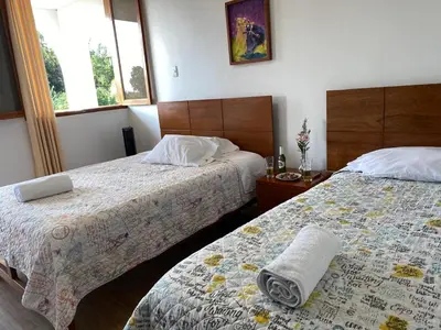 a hotel room with two beds with towels on them at HOTEL HACIENDA SUBTANJALLA CASABLANCA in Ica