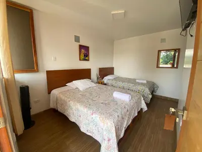 a hotel room with two beds and a window at HOTEL HACIENDA SUBTANJALLA CASABLANCA in Ica