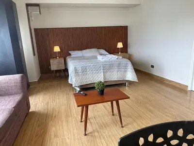a bedroom with a bed and a coffee table at Excelente ubicación San Isidro Suite 10 in Lima
