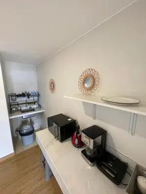 a kitchen with a counter with a coffee maker on it at Excelente ubicación San Isidro Suite 10 in Lima