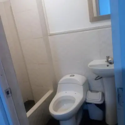 a small bathroom with a toilet and a sink at Residencial Salamanca in Lima