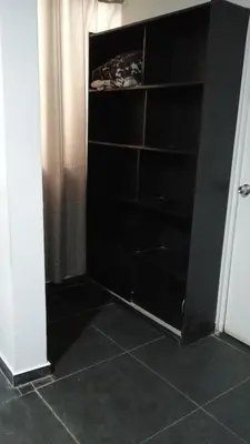 a closet with black shelves in a room at Residencial Salamanca in Lima