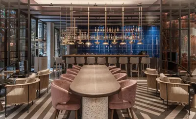 a restaurant with a table and chairs and a bar at Doubletree By Hilton Lima San Isidro in Lima