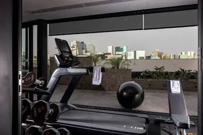 a gym with a treadmill and a view of a city at Doubletree By Hilton Lima San Isidro in Lima