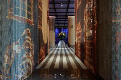 a hallway of a room with patterns on the walls at Doubletree By Hilton Lima San Isidro in Lima