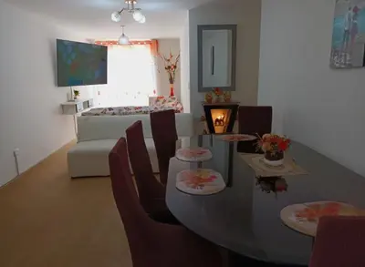 a living room with a table and chairs and a couch at lindo departamento Frente al mar in Lima