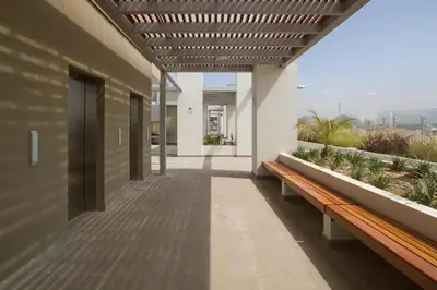 a hallway of a building with benches and plants at Apartment near to MIRAFLORES, BEACHES & REBAGLIATI HOSPITAL ! Panoramic View,Pool, Gym,Private Park in LINCE in Lima