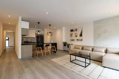 a living room and kitchen with a couch and a table at Caster by Wynwood House in Lima