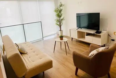 a living room with two chairs and a television at Sky1004 in Lima