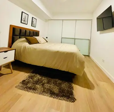 a bedroom with a large bed and a rug at Sky1004 in Lima