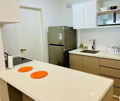 a kitchen with a white counter top with orange objects on it at Sky1004 in Lima