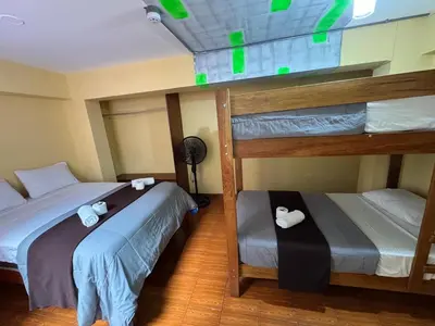 two bunk beds in a room with green lights at La Posada del Rey - Lima Airport Hostel in Lima