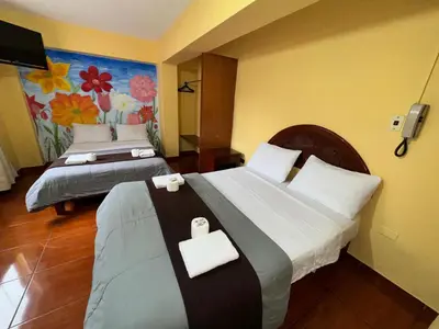 a hotel room with two beds and a painting on the wall at La Posada del Rey - Lima Airport Hostel in Lima