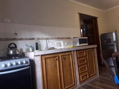 a kitchen with a stove and a refrigerator at Arcopata Apartamentos in Cusco
