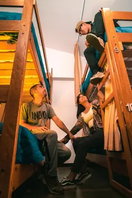 a group of people sitting on bunk beds at Magar Hostel Bar in Cusco