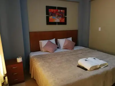a bedroom with a bed with two towels on it at Hostal Aventura Total Perú_lunahuana in Lunahuaná
