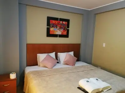 a bedroom with a bed with two towels on it at Hostal Aventura Total Perú_lunahuana in Lunahuaná