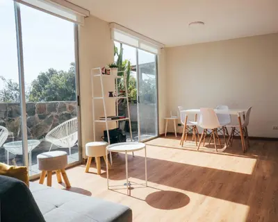 a living room with a table and chairs at Acogedor departamento con amplia terraza in Lima
