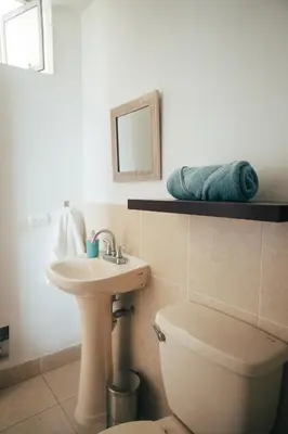 a bathroom with a sink and a toilet and a mirror at Acogedor departamento con amplia terraza in Lima