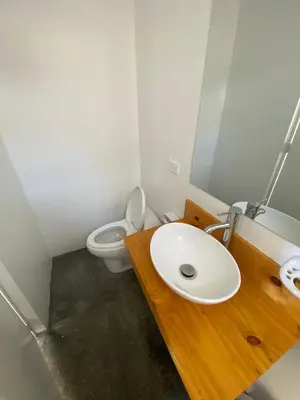 a bathroom with a sink and a toilet at Killamoon House Paracas in Paracas