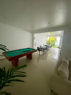 a living room with a pool table and a couch at Killamoon House Paracas in Paracas
