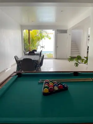 a pool table with balls on it in a living room at Killamoon House Paracas in Paracas
