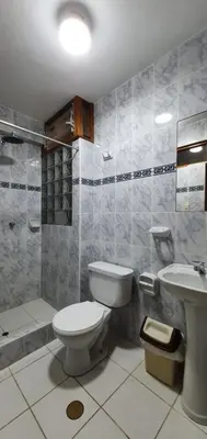 a bathroom with a toilet and a sink at Hotel Romero Machupicchu in Machu Picchu