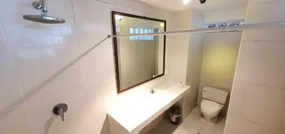 a bathroom with a sink and a toilet and a mirror at Hotel Romero Machupicchu in Machu Picchu