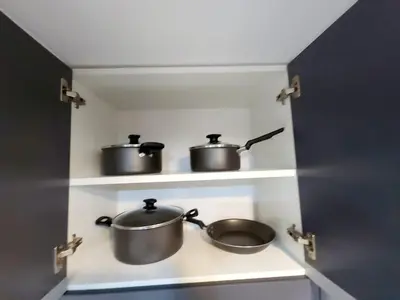 two pots and pans on a shelf in a kitchen at Acogedor departamento en Huacachina in Ica