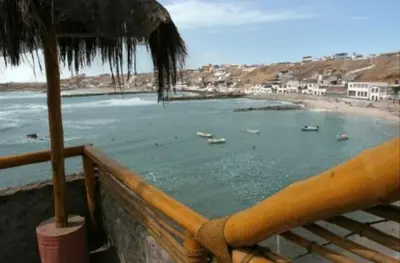 a view of a beach with boats in the water at Posada del Mirador Italyan Villa in San Bartolo