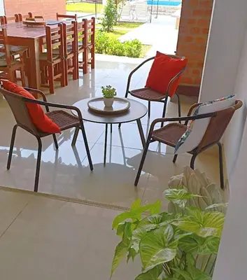 a patio with three chairs and a table and a table with a table at Amplia Casa de Campo con Piscina en Cieneguilla in Cieneguilla