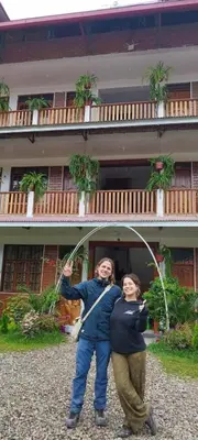 two people standing in front of a building at Hospedaje Oxa Paraíso in Oxapampa