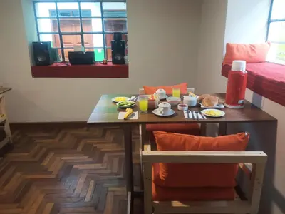 a room with a table with food and drinks on it at Hostel Tupac Yupanqui House in Cusco