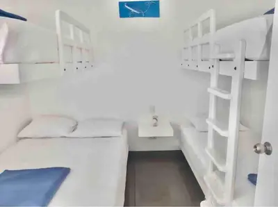 a room with two bunk beds and a desk at Departamento Paracas vista al mar in Paracas