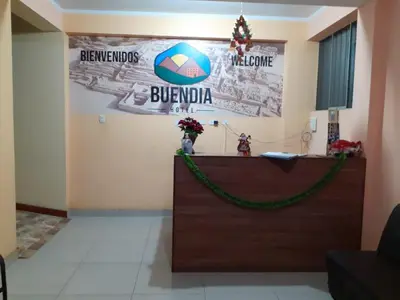 a reception desk in a room with a sign on the wall at BUENDIA HOTEL in Pueblo Viejo
