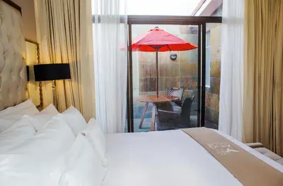 a hotel room with a bed and a red umbrella at Atiq Boutique Hotel in Cusco