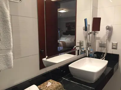 a bathroom with a white sink and a mirror at Atiq Boutique Hotel in Cusco