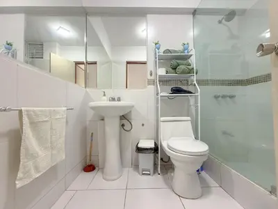 a bathroom with a toilet and a sink and a shower at Departamento en el corazón de Miraflores in Lima