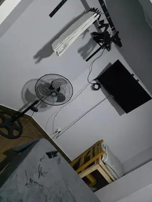 a white room with a fan on the ceiling at Casa sabina nuevo aeropuerto in Lima
