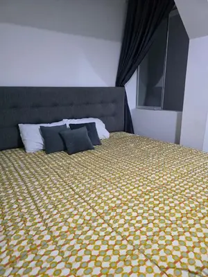 a bedroom with a bed with a yellow and white bedspread at Casa sabina nuevo aeropuerto in Lima