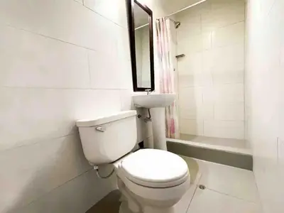 a bathroom with a white toilet and a sink at Casa Justina in Cusco