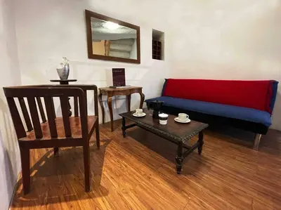 a living room with a couch and a chair and a table at Casa Justina in Cusco
