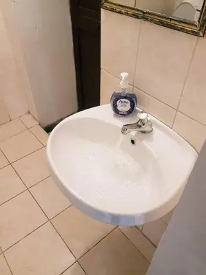 a white sink in a bathroom with a mirror at Nico Homes in Cusco
