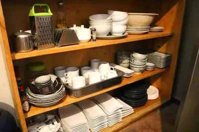 a wooden shelf with plates and cups and dishes at Nico Homes in Cusco